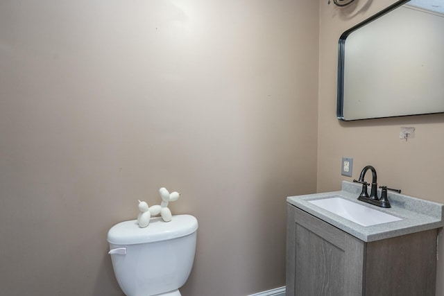 bathroom featuring toilet and vanity