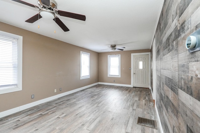 entrance foyer featuring a ceiling fan, wood finished floors, baseboards, and visible vents