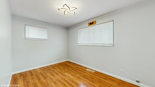 1317 Mackinaw Ave, Calumet City, IL 60409 - empty room with baseboards, light wood finished floors, and visible vents