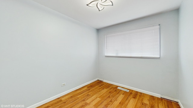1317 Mackinaw Ave, Calumet City, IL 60409 - empty room with visible vents, baseboards, and light wood finished floors