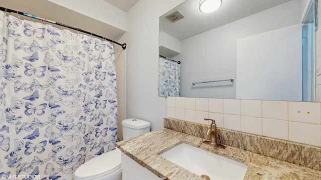 1317 Mackinaw Ave, Calumet City, IL 60409 - full bath featuring visible vents, vanity, toilet, and tasteful backsplash