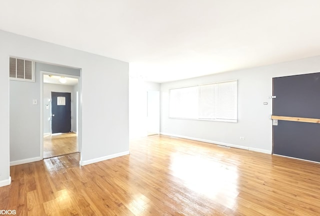 1317 Mackinaw Ave, Calumet City, IL 60409 - unfurnished living room with baseboards, light wood-style flooring, and visible vents