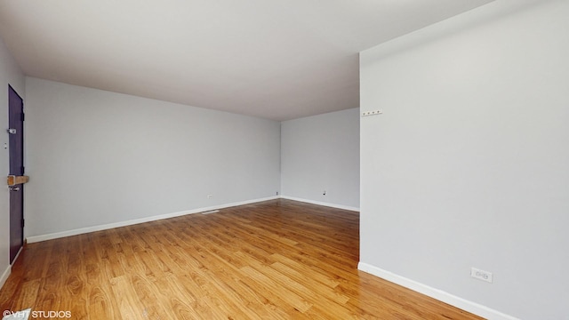 1317 Mackinaw Ave, Calumet City, IL 60409 - spare room featuring baseboards and light wood-type flooring