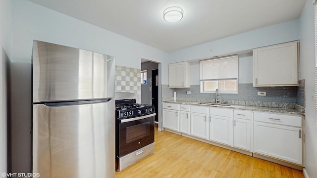 1317 Mackinaw Ave, Calumet City, IL 60409 - kitchen with stainless steel appliances, white cabinetry, a sink, and tasteful backsplash