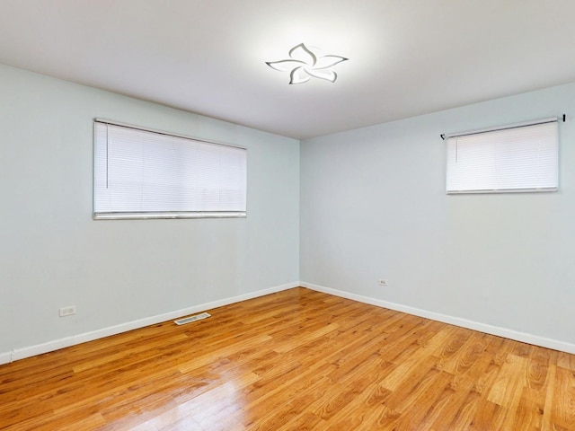 1317 Mackinaw Ave, Calumet City, IL 60409 - spare room featuring baseboards, light wood finished floors, and visible vents