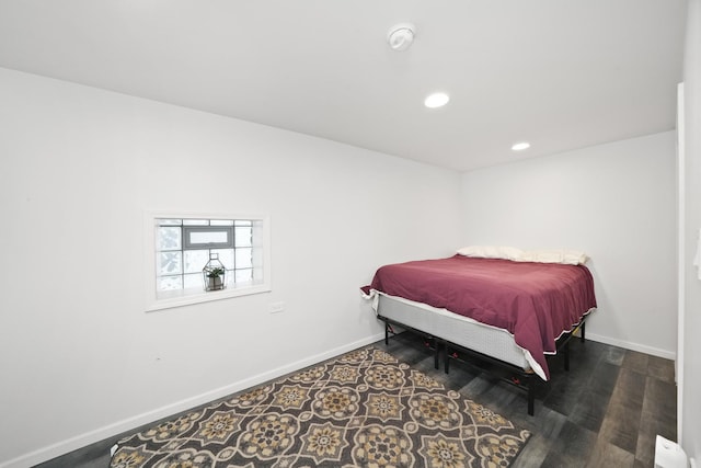bedroom with baseboards, recessed lighting, and wood finished floors