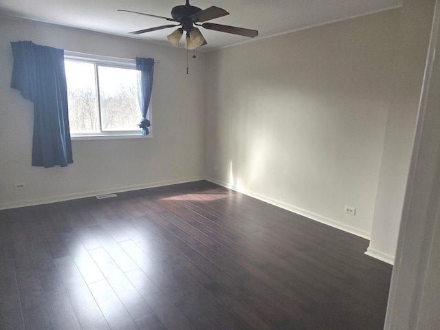 unfurnished room featuring a ceiling fan, baseboards, and dark wood finished floors