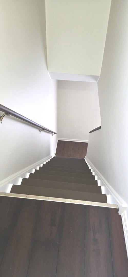 stairway with baseboards and wood finished floors