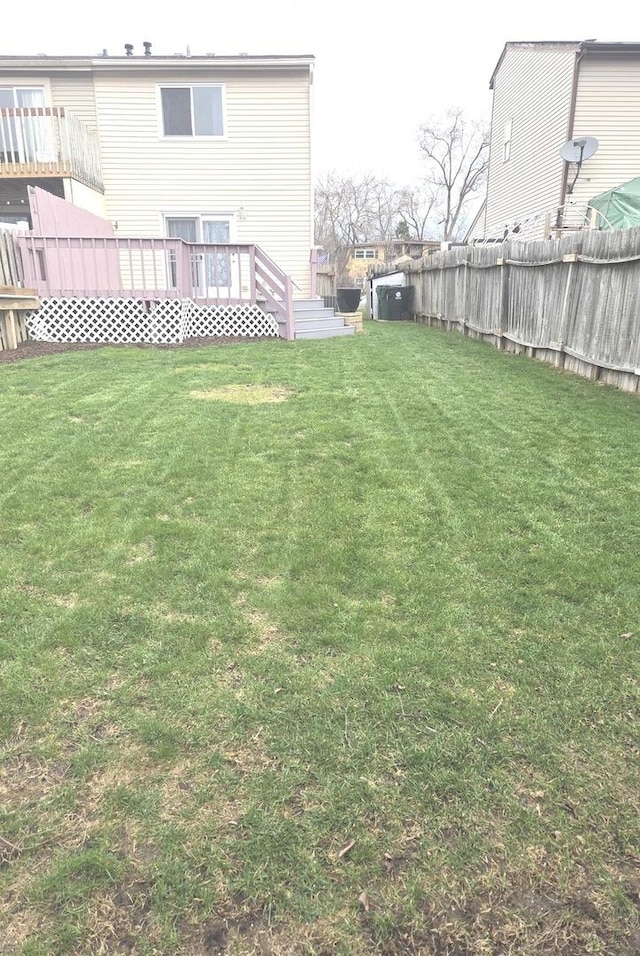 view of yard featuring fence and a wooden deck