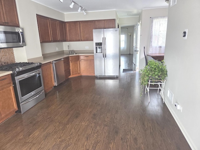 kitchen featuring light countertops, visible vents, appliances with stainless steel finishes, a sink, and dark wood-style floors