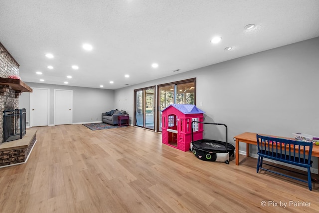 3134 Chellington Dr, Johnsburg, IL 60051 - recreation room featuring baseboards, a fireplace, recessed lighting, and light wood finished floors