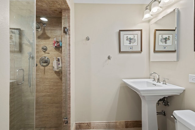 bathroom with toilet and a shower stall