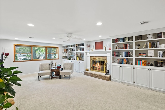 sitting room with carpet, ceiling fan, a fireplace, recessed lighting, and baseboards