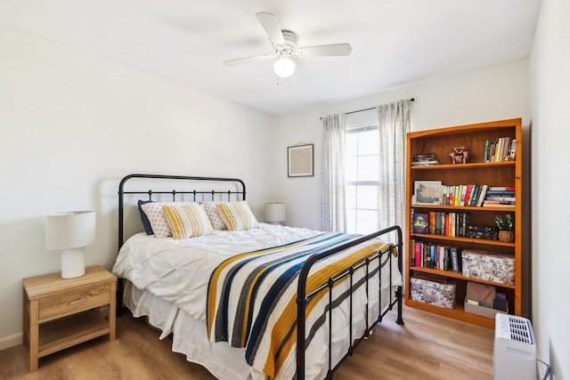 bedroom with a ceiling fan and wood finished floors