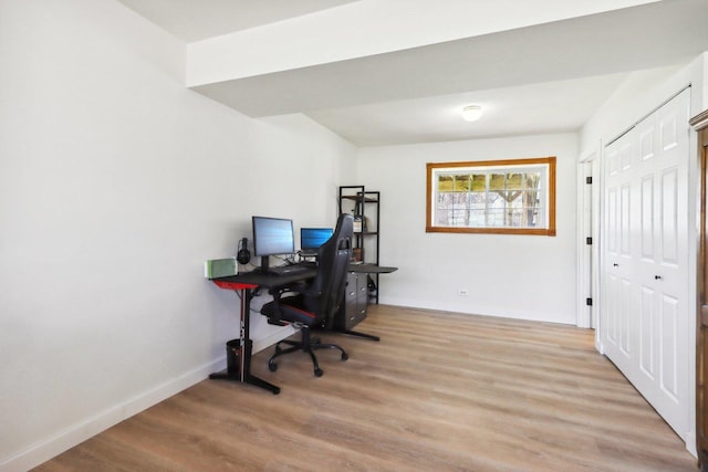 home office with baseboards and light wood-type flooring