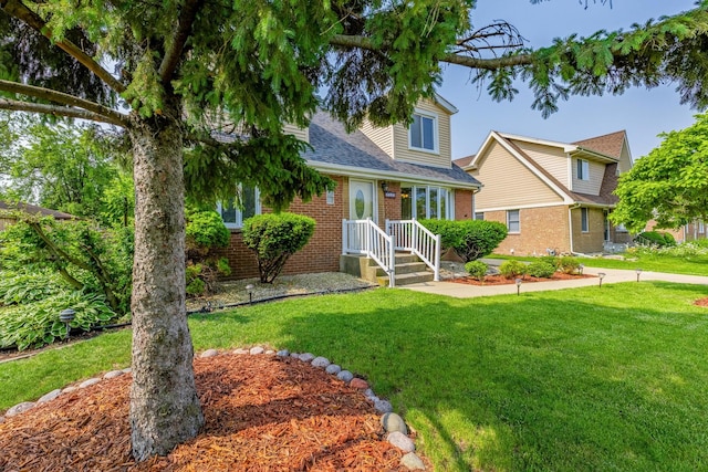 7733 Suburban Ln, Bridgeview, IL 60455 - view of front facade featuring brick siding, a front yard, and roof with shingles