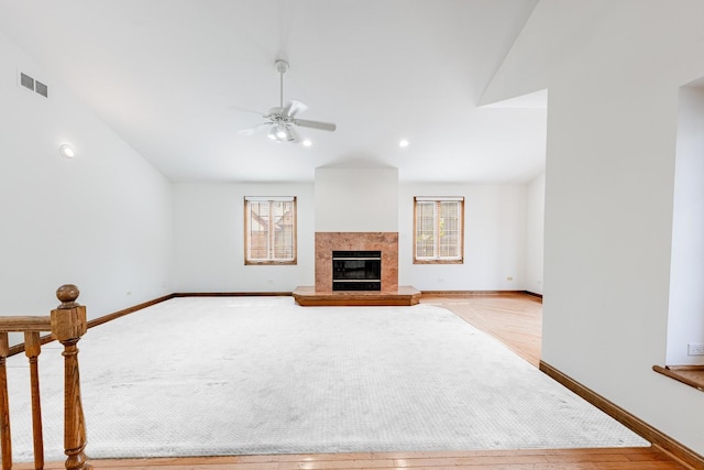 7733 Suburban Ln, Bridgeview, IL 60455 - unfurnished living room featuring a ceiling fan, a fireplace, and light wood-type flooring