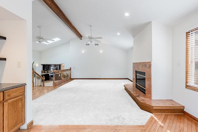 7733 Suburban Ln, Bridgeview, IL 60455 - living area with a tiled fireplace, ceiling fan, light wood-style floors, recessed lighting, and a skylight