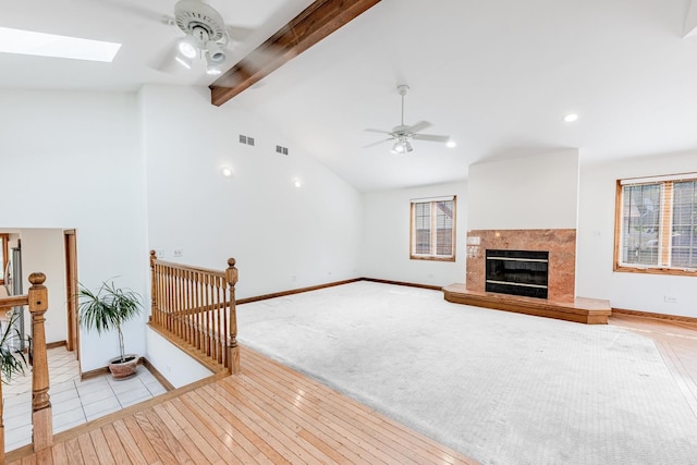 7733 Suburban Ln, Bridgeview, IL 60455 - unfurnished living room with a ceiling fan, a premium fireplace, light wood-style flooring, a skylight, and recessed lighting