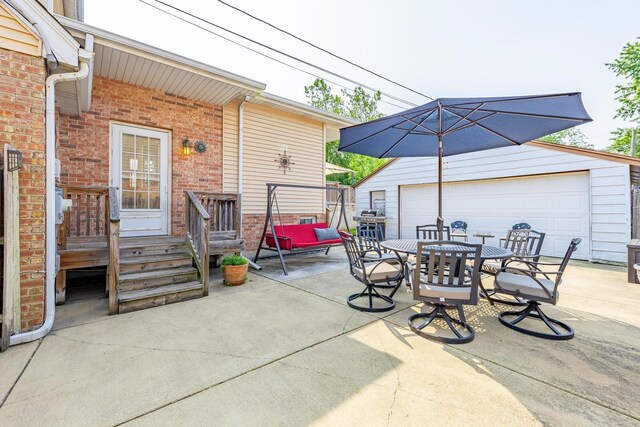 7733 Suburban Ln, Bridgeview, IL 60455 - view of patio featuring a garage, an outbuilding, and outdoor dining space
