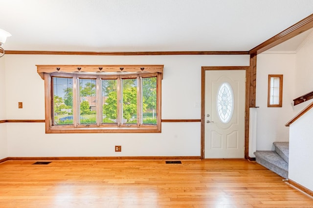 7733 Suburban Ln, Bridgeview, IL 60455 - foyer featuring light wood finished floors, stairway, and crown molding