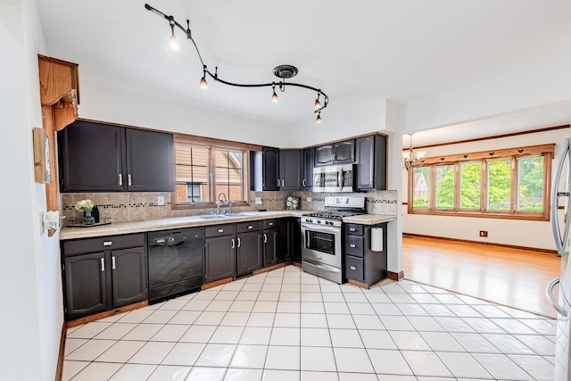 7733 Suburban Ln, Bridgeview, IL 60455 - kitchen with stainless steel appliances, light countertops, decorative backsplash, and a chandelier