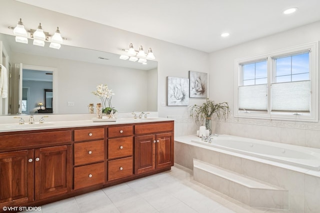 ensuite bathroom with double vanity, a sink, a garden tub, and tile patterned floors