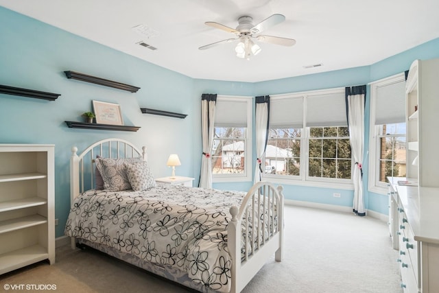 carpeted bedroom with baseboards, visible vents, and a ceiling fan