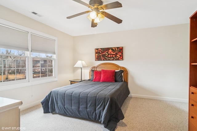 carpeted bedroom featuring baseboards, visible vents, and a ceiling fan
