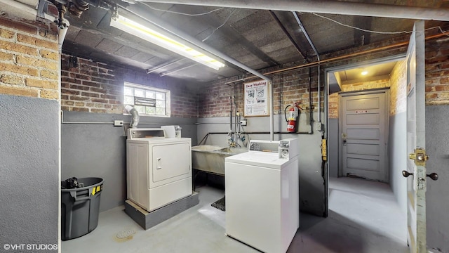 502 Bonnie Brae Pl Unit C2, River Forest, IL 60305 - laundry area with laundry area, washer and clothes dryer, a sink, and brick wall