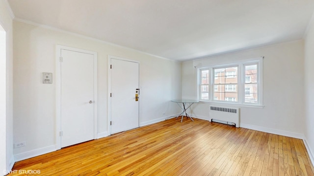 502 Bonnie Brae Pl Unit C2, River Forest, IL 60305 - unfurnished room with baseboards, light wood-style flooring, radiator, and ornamental molding