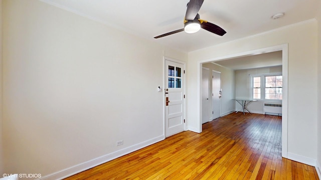 502 Bonnie Brae Pl Unit C2, River Forest, IL 60305 - empty room with light wood-style floors, radiator, ceiling fan, and baseboards