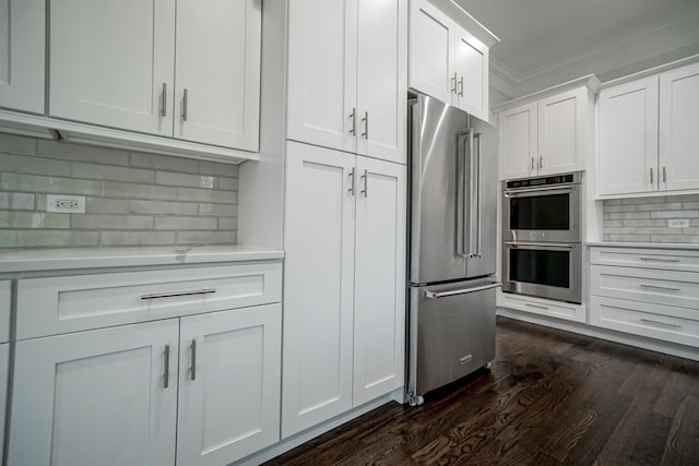 kitchen with light countertops, tasteful backsplash, crown molding, stainless steel appliances, and dark wood finished floors