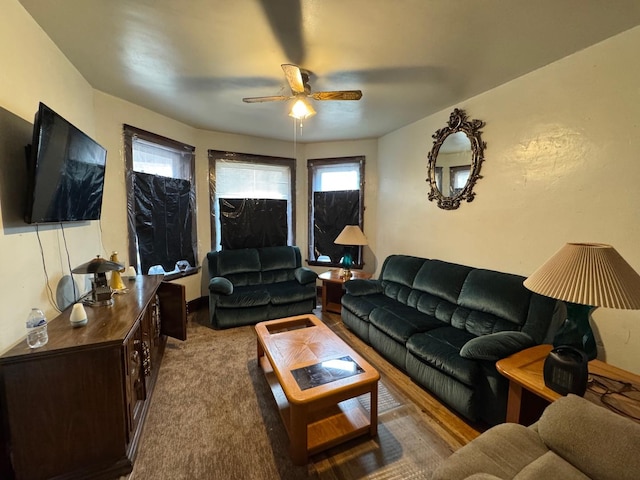 carpeted living area featuring ceiling fan