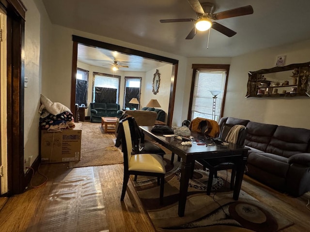 dining space with wood finished floors and a ceiling fan