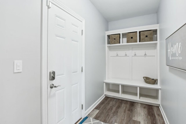 mudroom featuring dark wood-style flooring and baseboards
