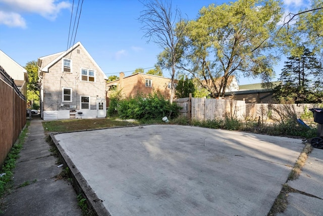 rear view of house featuring fence