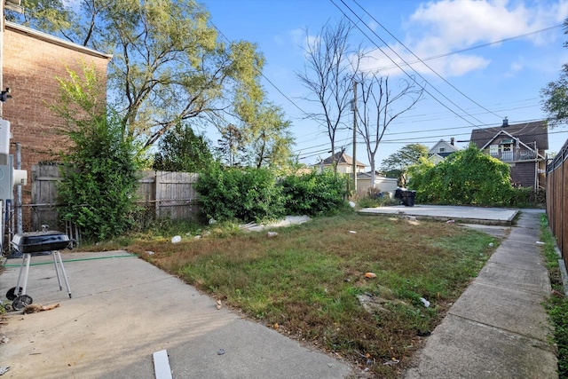 view of yard featuring fence and a patio area