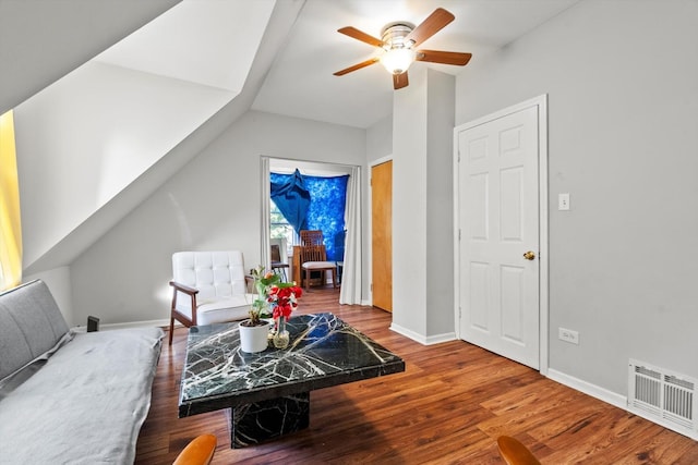 living area featuring wood finished floors, a ceiling fan, visible vents, baseboards, and lofted ceiling