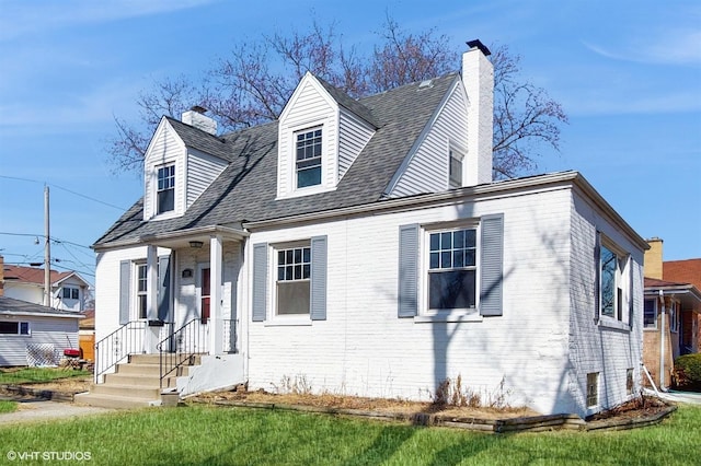 cape cod house with brick siding and a chimney