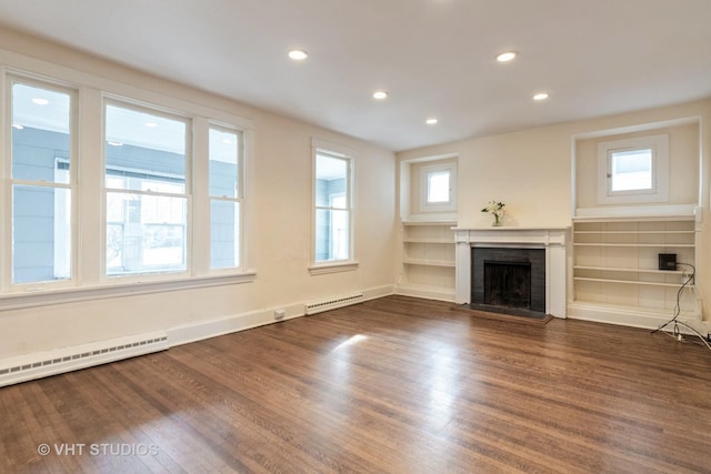 unfurnished living room with a baseboard radiator, a brick fireplace, dark wood-style floors, and recessed lighting