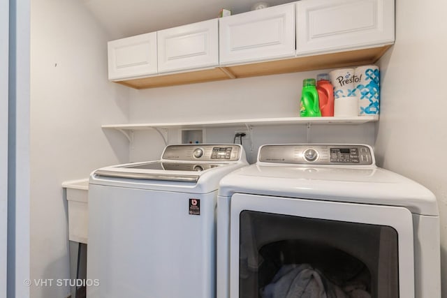 clothes washing area with cabinet space and washing machine and clothes dryer