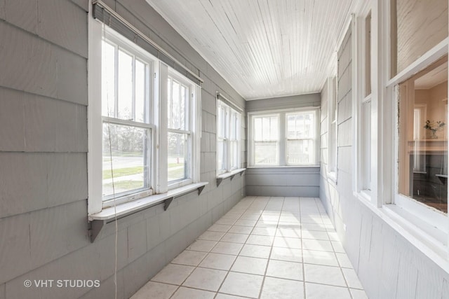 unfurnished sunroom with tile patterned floors