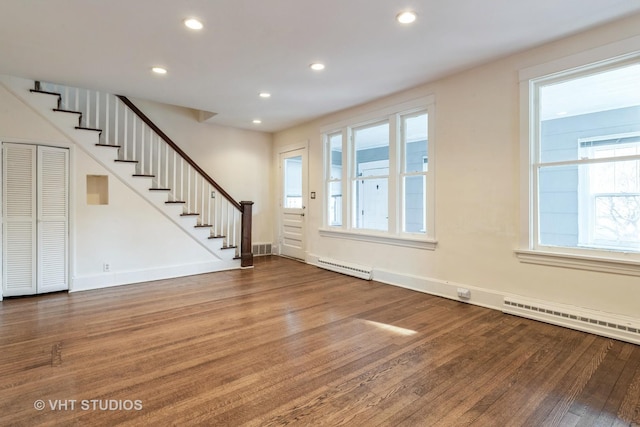 interior space featuring stairs, wood finished floors, and plenty of natural light
