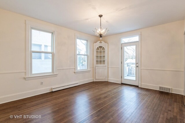 unfurnished dining area with dark wood-style flooring, a chandelier, visible vents, and a healthy amount of sunlight