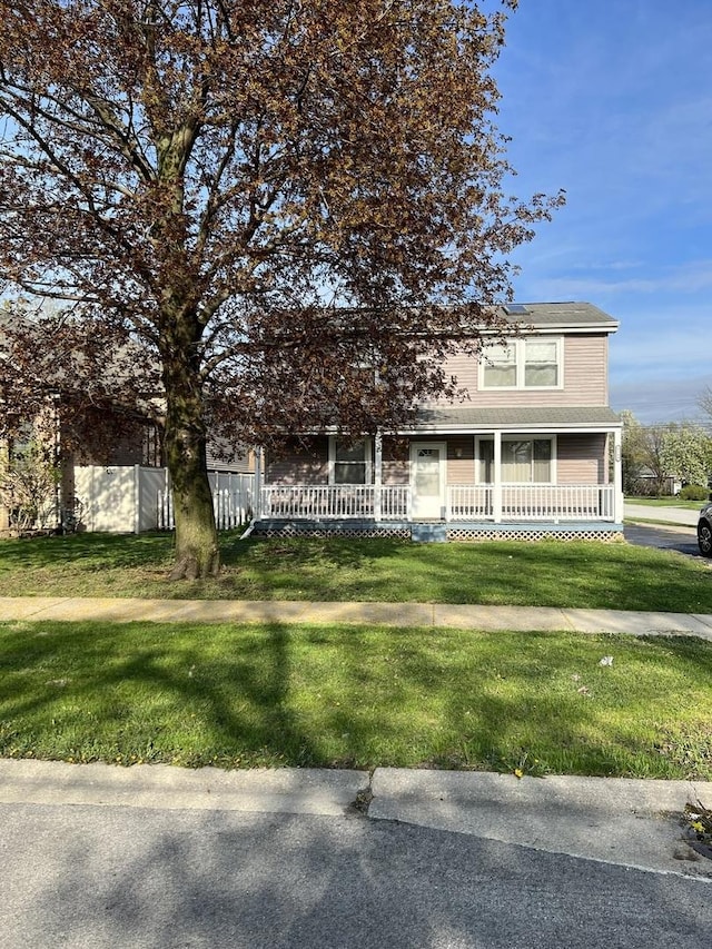 view of front of house featuring covered porch and a front lawn