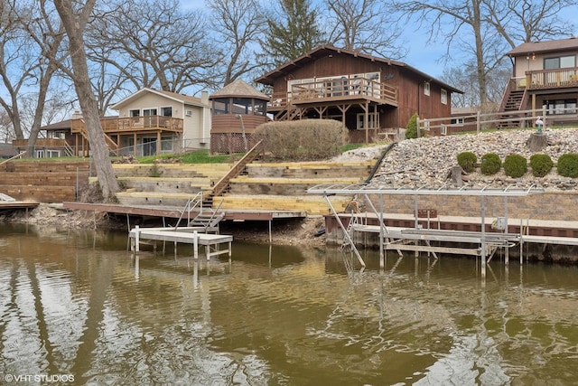 dock area with a deck with water view and stairs