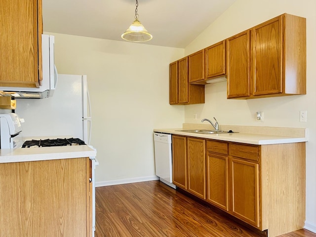 kitchen with lofted ceiling, dark wood-style flooring, a sink, and white appliances
