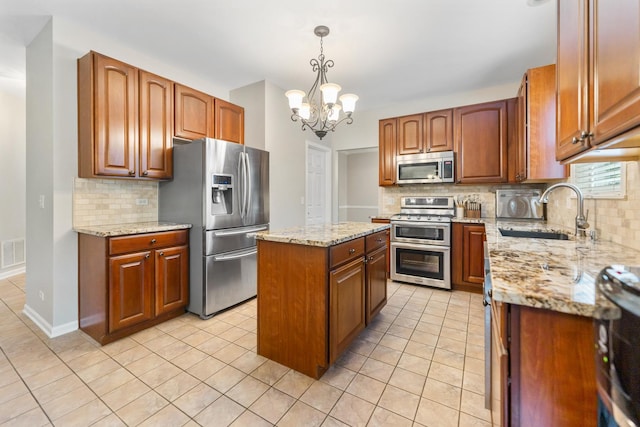 2571 Rourke Dr, Aurora, IL 60503 - kitchen with stainless steel appliances, a sink, decorative backsplash, and a chandelier