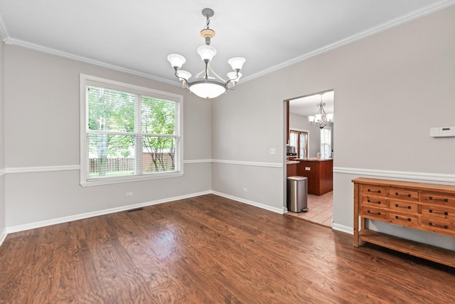 2571 Rourke Dr, Aurora, IL 60503 - spare room featuring a chandelier, plenty of natural light, wood finished floors, and crown molding